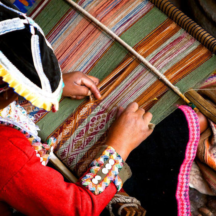 a woman weaving fabrics
