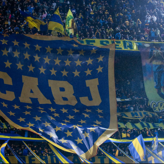 A giant flag with the shape of Boca Juniors shield, inside La Bombonera stadium