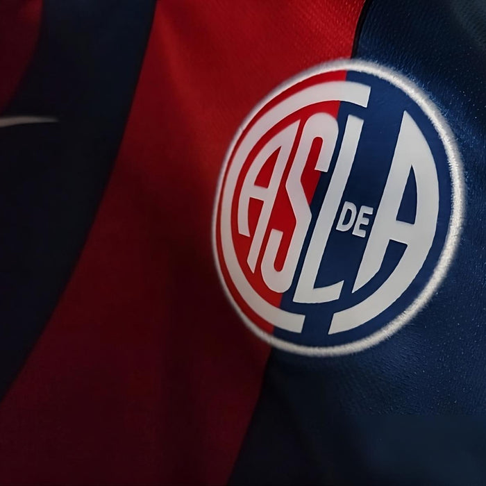 Close up to a San Lorenzo football shirt, where the letters CASLA can be read