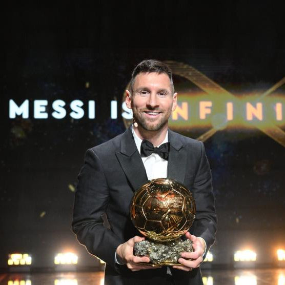 Lionel Messi holding his eight Ballon d'Or