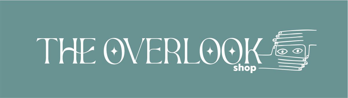 The logo of the brand. The text "THE OVERLOOK shop" in white can be read over a teal background. To the right, there is a drawing of a pair of eyes surrounded by two hands